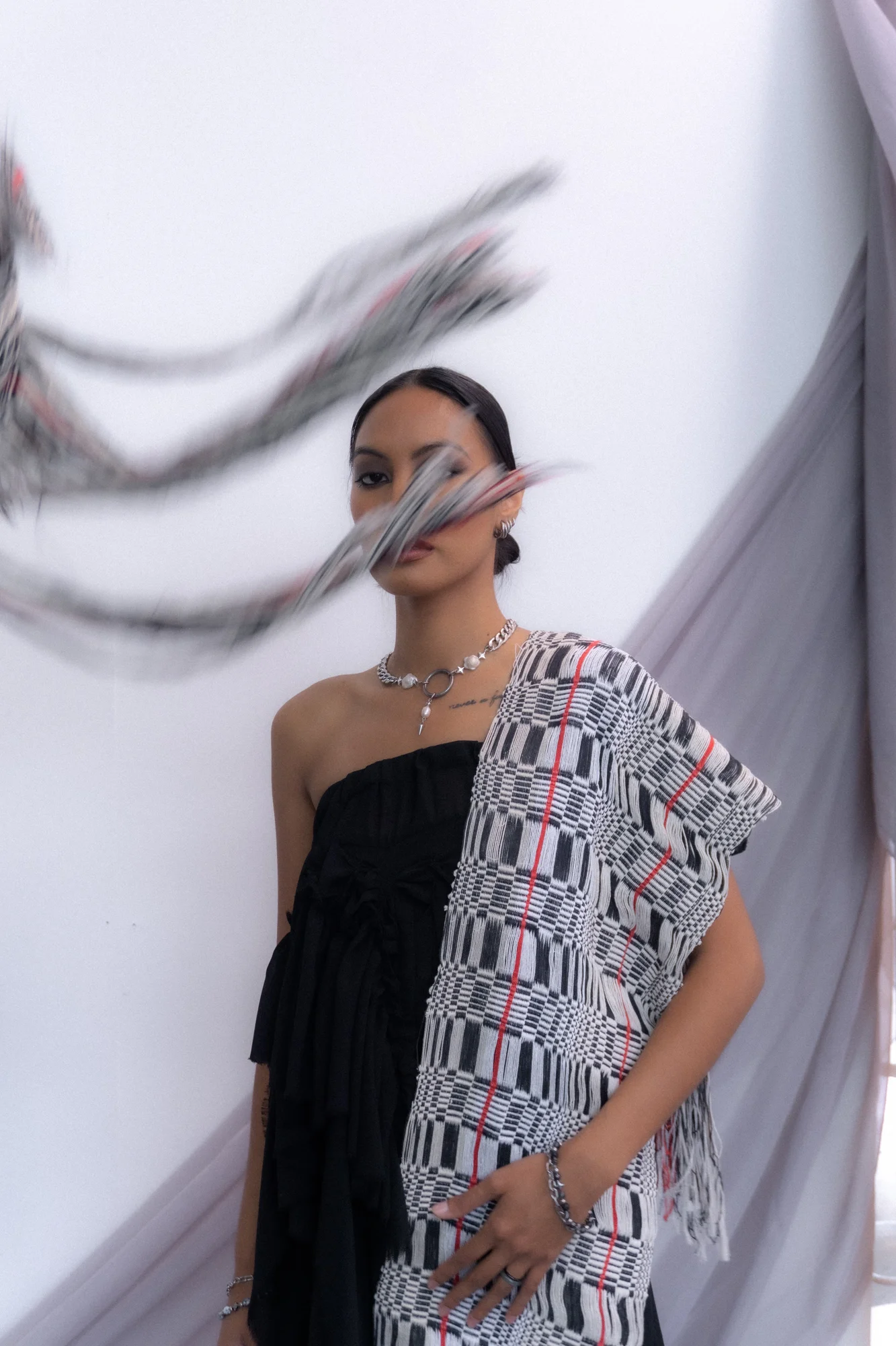 Portrait with a woven textile extending across the face