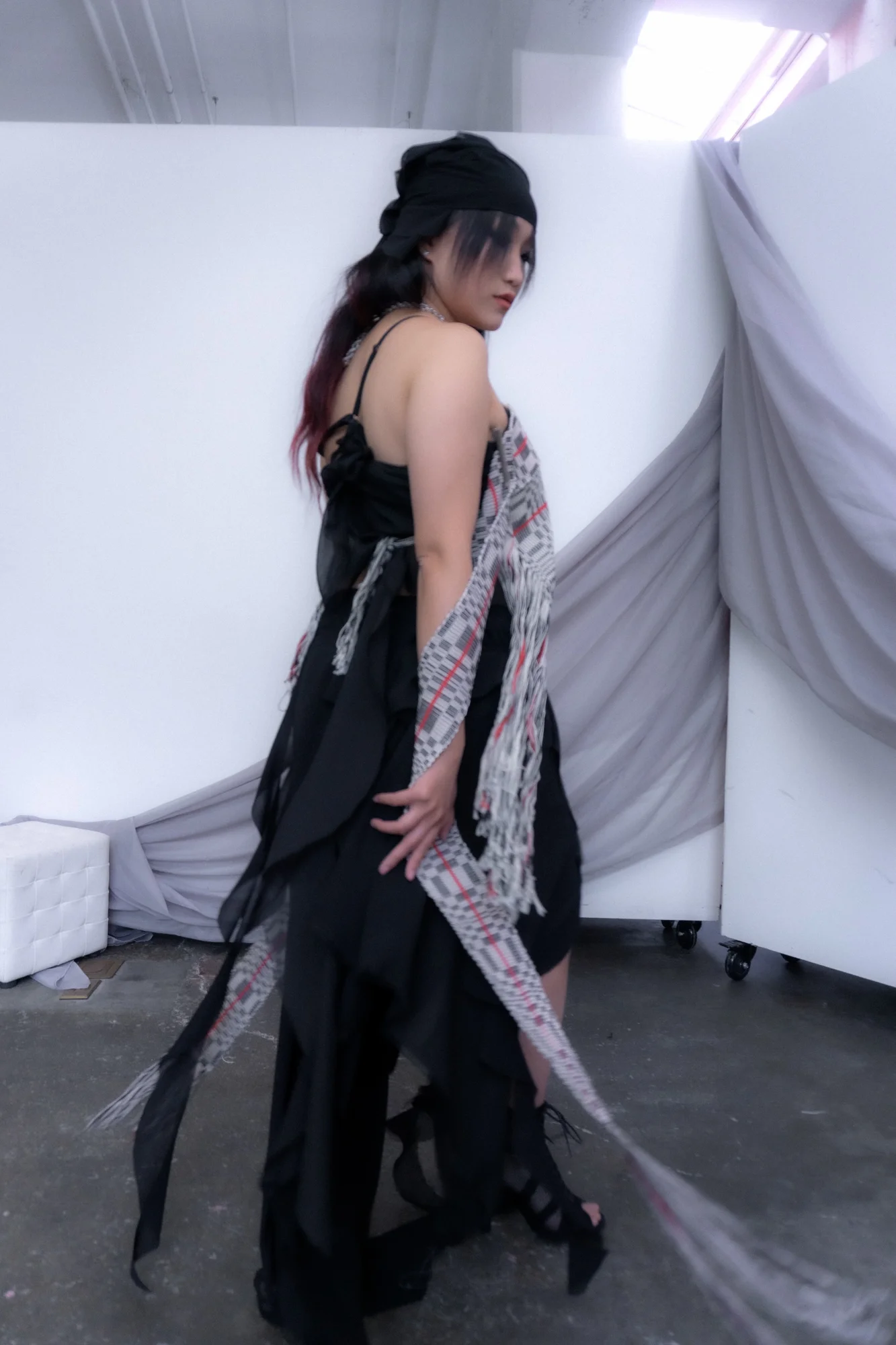 Side view of a black dress with a woven textile